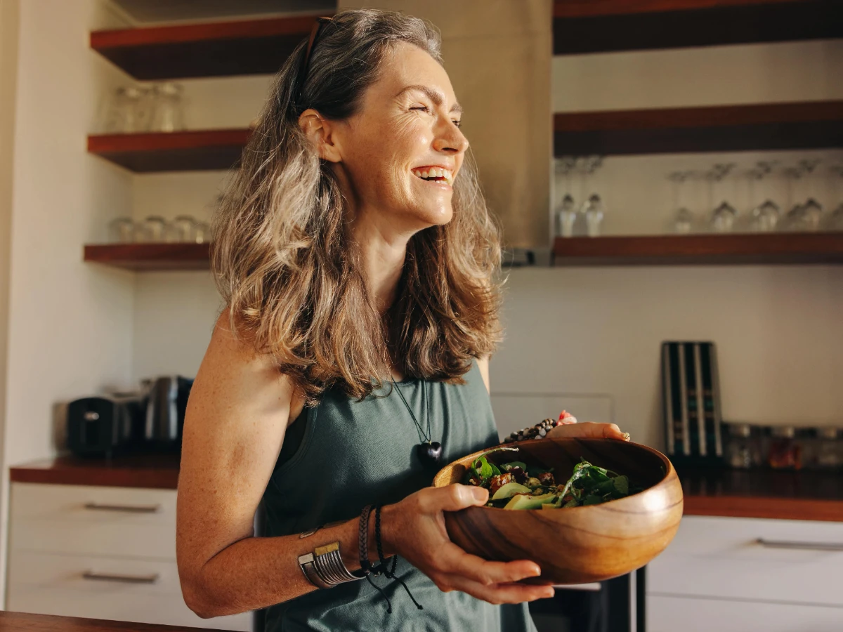  Frau hält Schüssel mit Salat in den Händen 