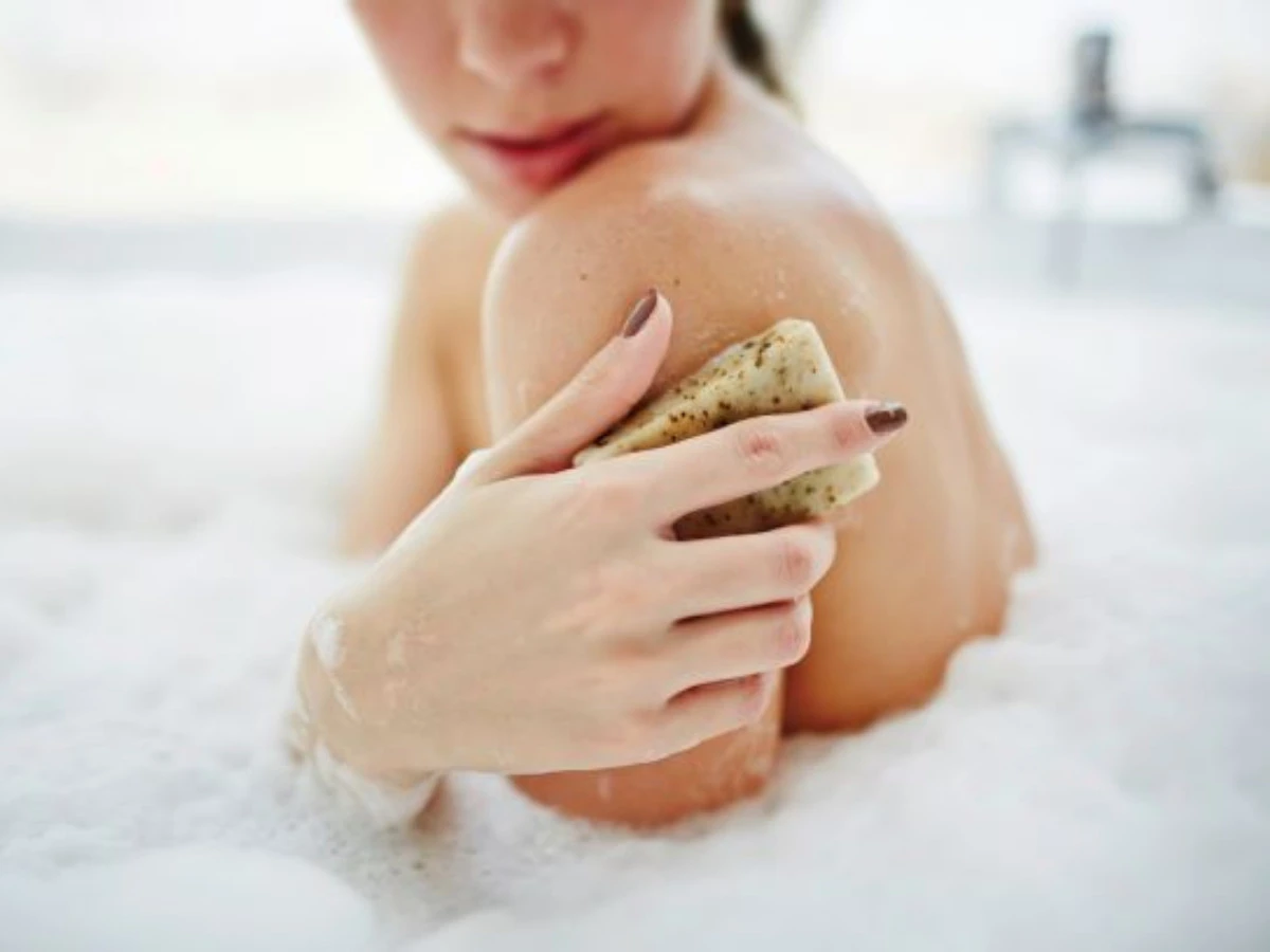  Frau wäscht sich mit festem Duschgel 